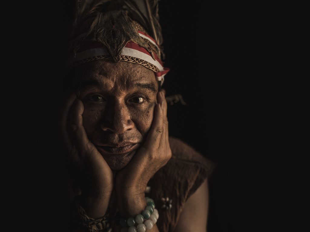 an old man wearing traditional clothes from Borneo Island Cuca Bali