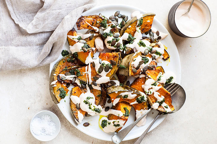 tasty pumpkin in a white plate with two spoons presented by Cuca Bali
